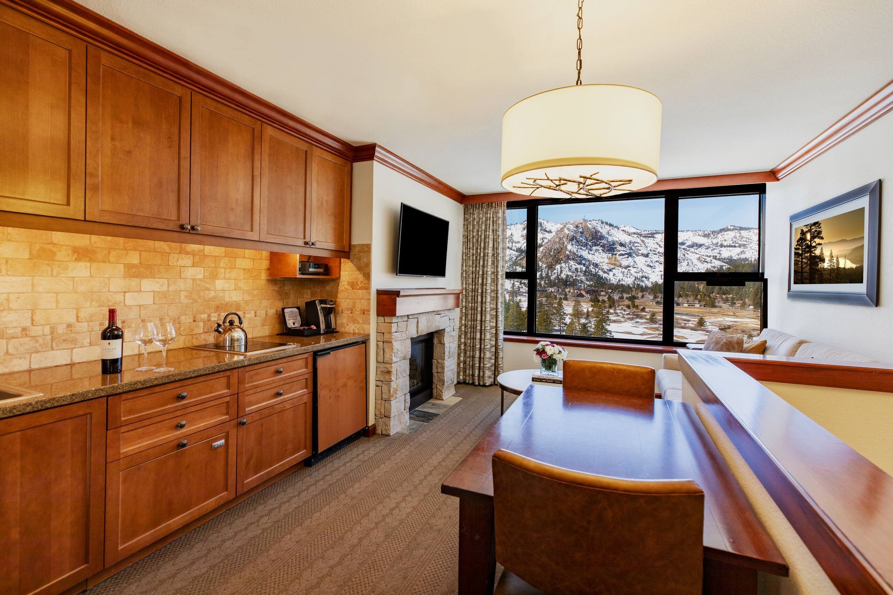 Everline suite kitchenette, dining, and fireplace living area