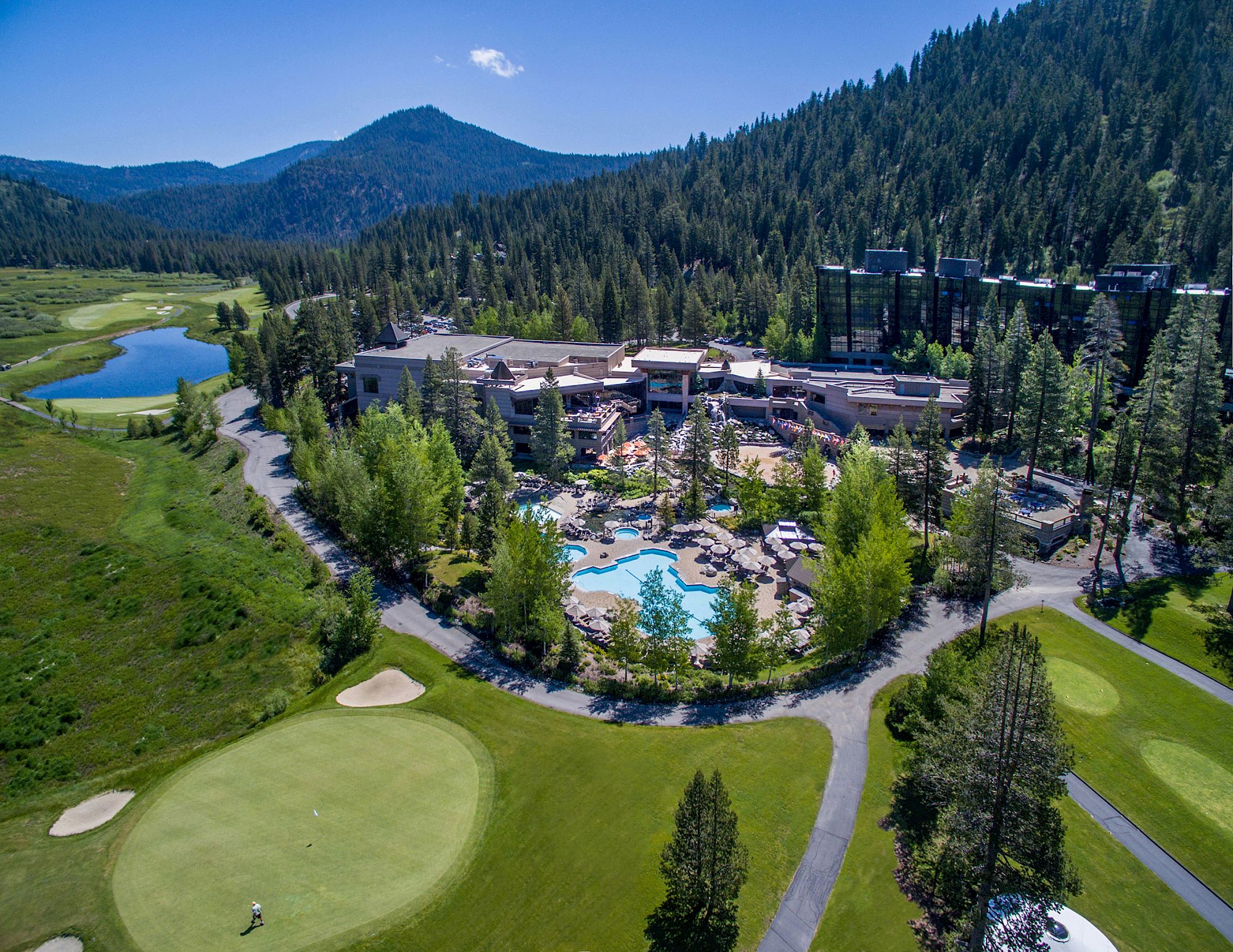Aerial view of Everline Midrise, pools, and Olympic Valley mountains
